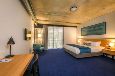 Work desk, balcony & bed in a Suite, Nesuto Curtin Perth Hotel