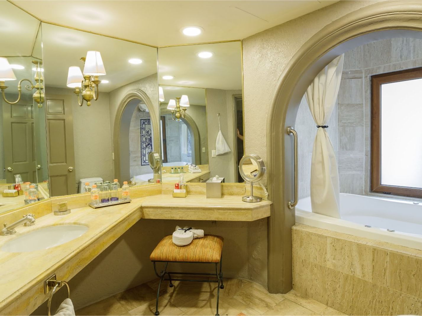 King Governor Suite Spacious marble bathroom featuring a double vanity and large arched mirrors at Quinta Real Guadalajara