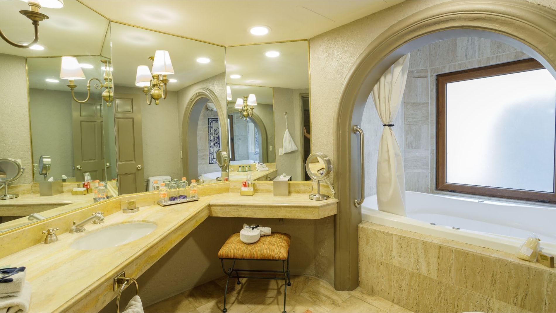 King Governor Suite Spacious marble bathroom featuring a double vanity and large arched mirrors at Quinta Real Guadalajara