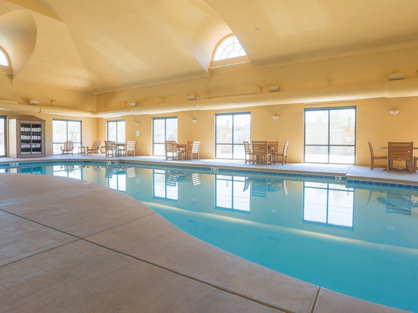 Dining tables alongside the indoor pool at Music Road Resort