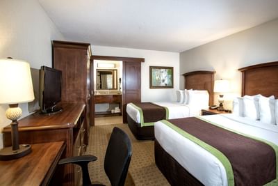 Beds & work desk with a TV in Deluxe Double Room at Rosen Inn Lake Buena Vista