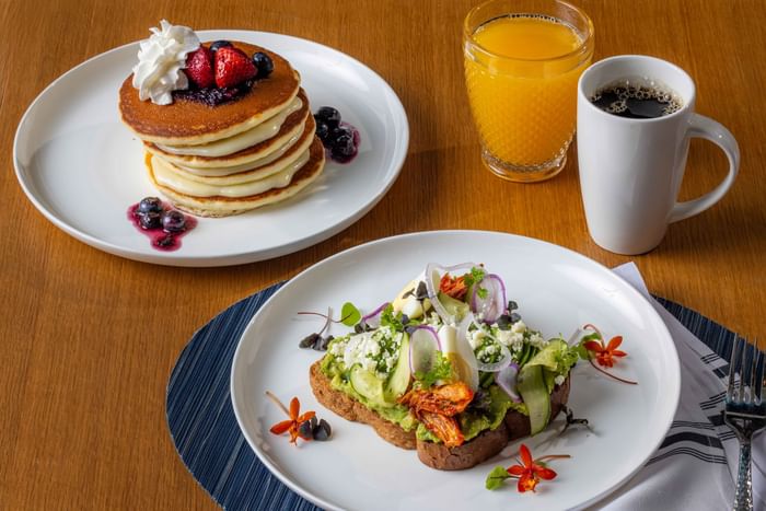 Avocado toast and pancakes served along with orange juice and coffee at Point Royal, The Diplomat Resort