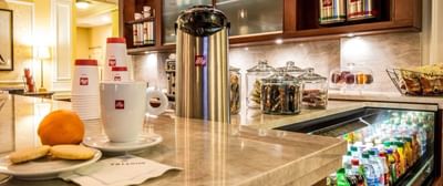 Snacks, hot beverages & cups on a counter at Trianon Bonita Bay