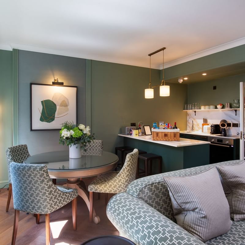 Spacious suite at Warwick Hotels and Resorts, with a modern dining table and a well-equipped kitchenette