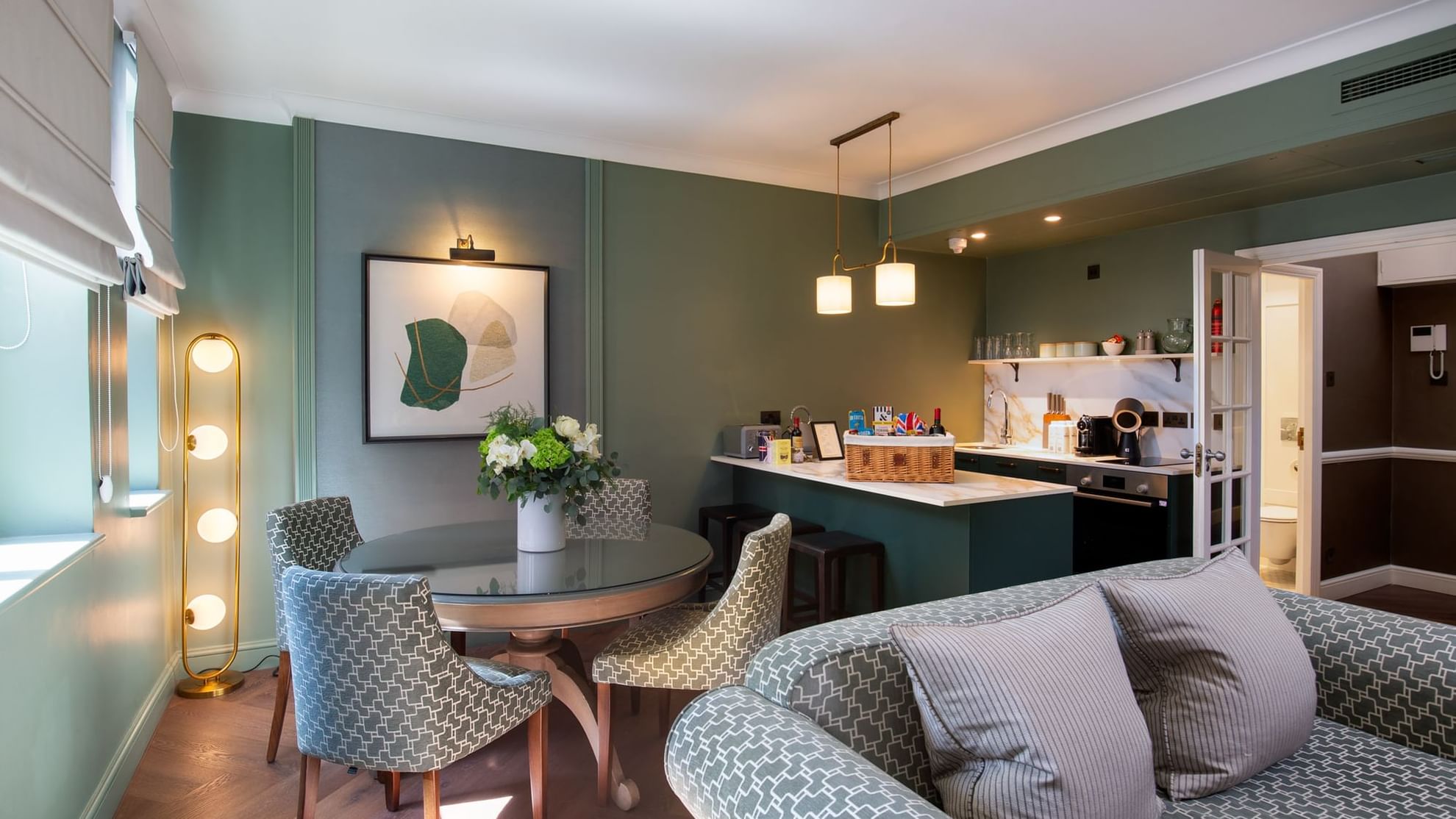 Spacious suite at Warwick Hotels and Resorts, with a modern dining table and a well-equipped kitchenette