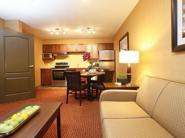 a couch and kitchen in a hotel room