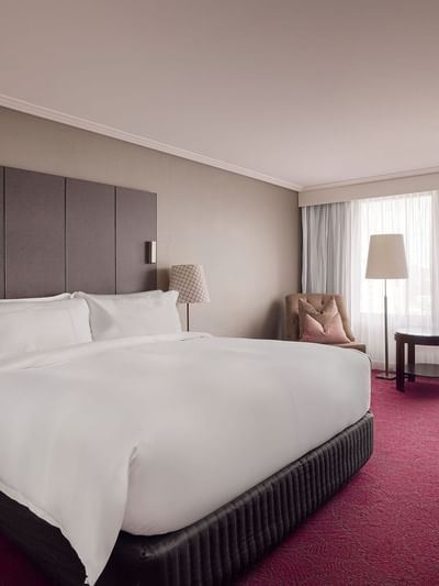 Work desk and lounge chair by the bed in Superior Room at Sofitel Brisbane Central