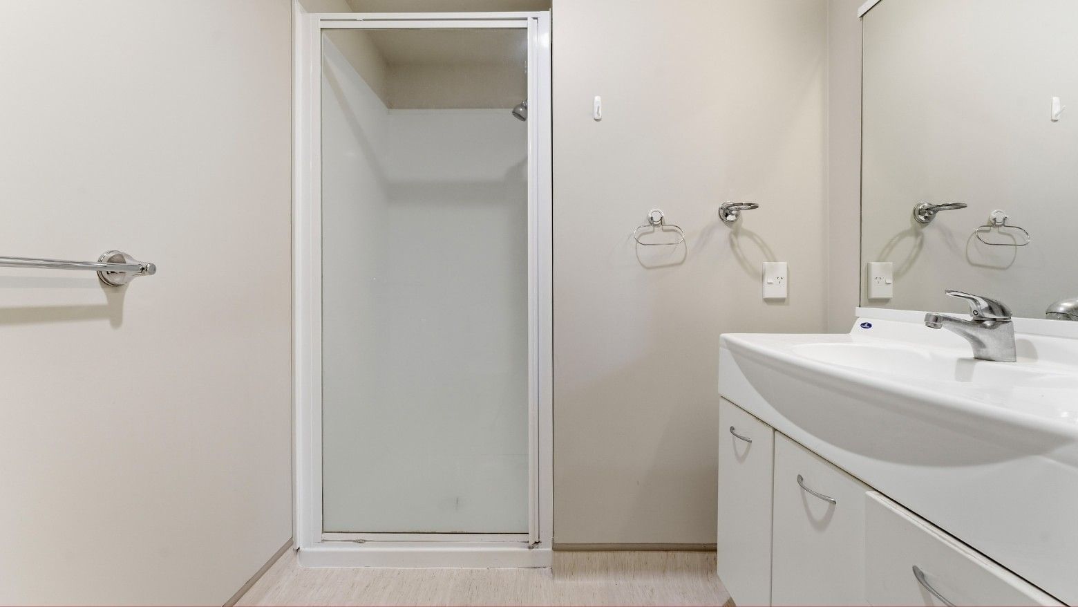 Modern bathroom with shower, sink, and white cabinets at UniLodge Stafford House.