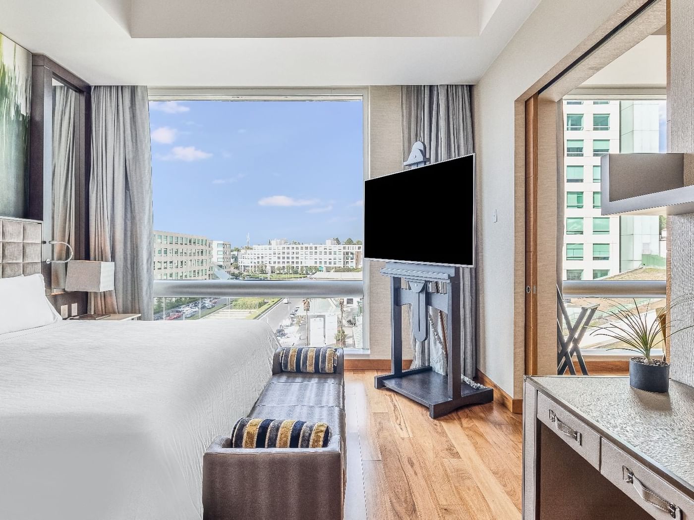 Master Suite 1 King with TV and city view at Fiesta Americana Travelty