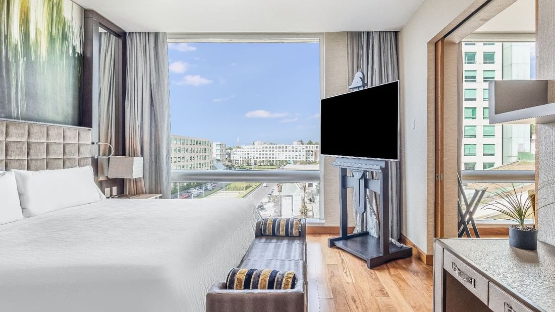 Master Suite 1 King with TV and city view at Fiesta Americana Travelty