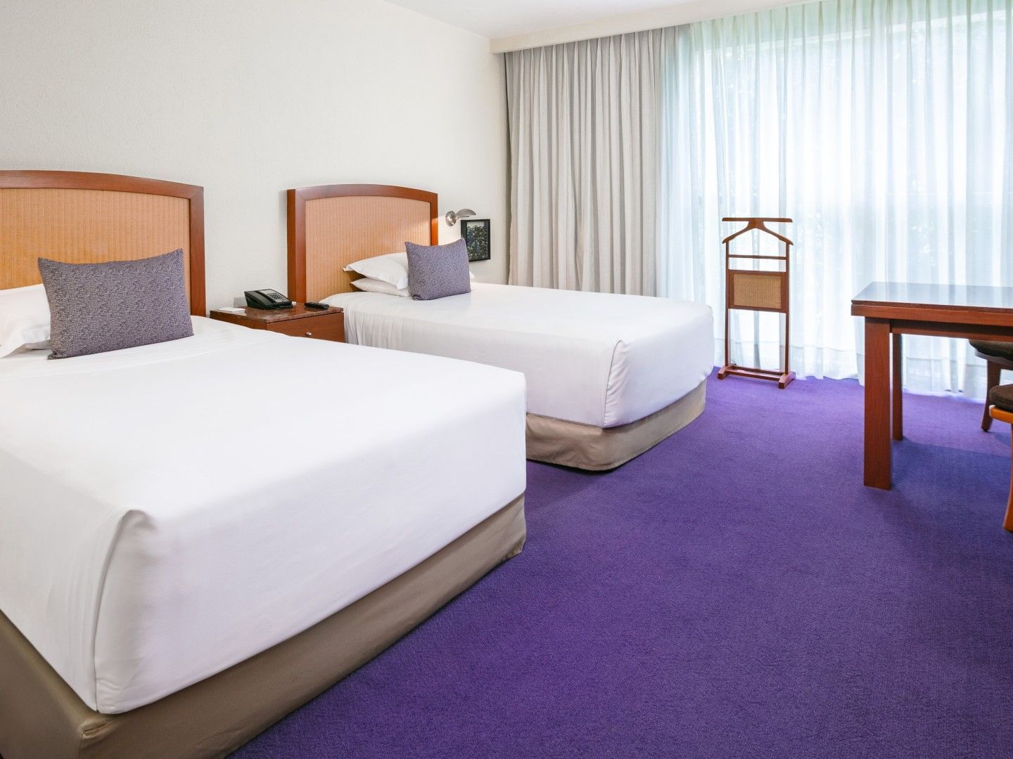 2 Double Deluxe room with twin beds, purple carpet, and a wooden valet stand by the window at Camino Real Polanco Mexico