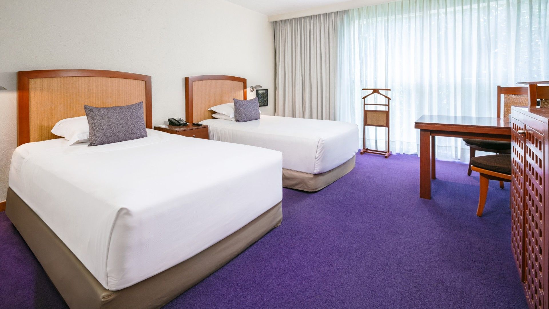2 Double Deluxe room with twin beds, purple carpet, and a wooden valet stand by the window at Camino Real Polanco Mexico