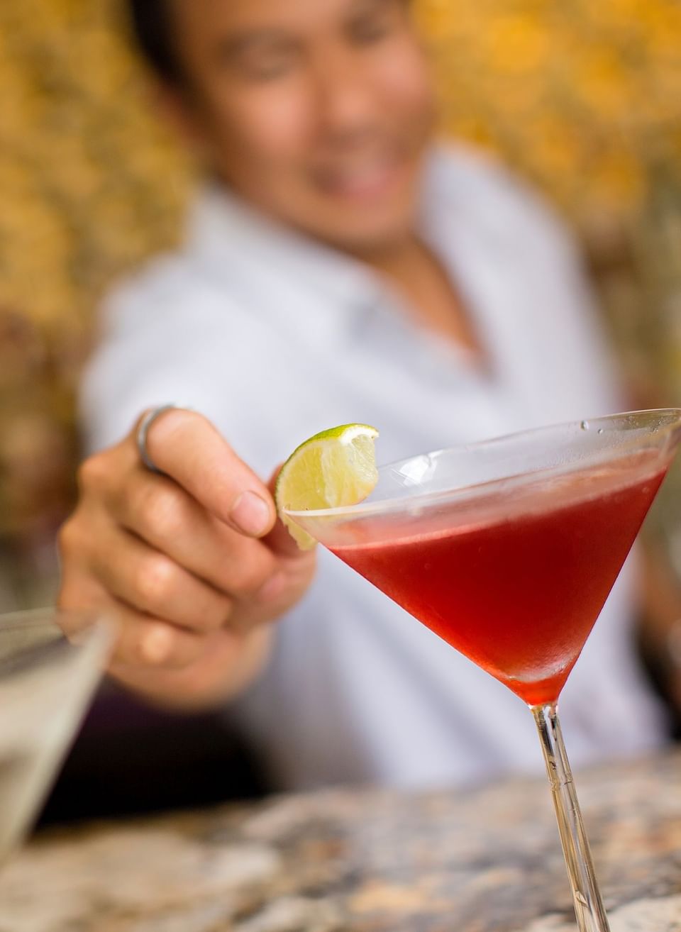 Close-up of a chef garnishing a drink at Maui Coast Hotel