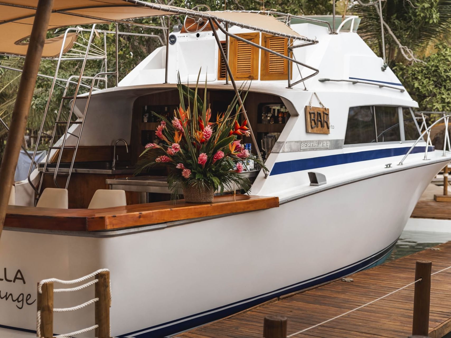 Close-up of a boat tied up at the wooden dock in Donatella Bar at Hotel Isla Del Encanto