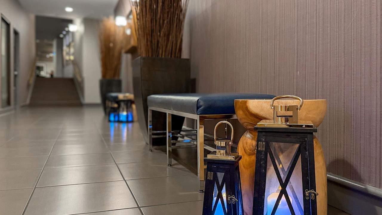 Stylish hallway with bench and lanterns at Coast Bastion Hotel.