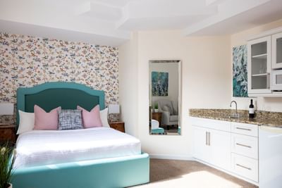 Cozy bed, nightstand, pantry & mirror in Queen Premiere at Retro Suites Hotel