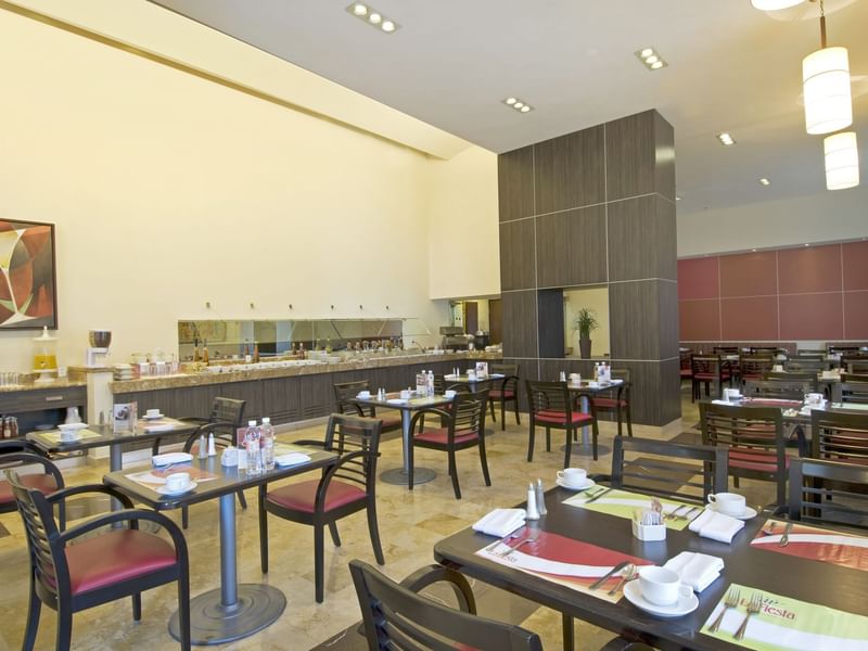Restaurant with dining set tables and chairs at Fiesta Inn