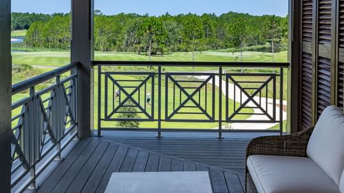 Balcony lounge area overlooking the golf ground in Junior Golf Suite at Camp Creek Inn