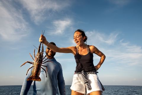 Close up of a lady catching a lobster at Golden Rock Resort 
