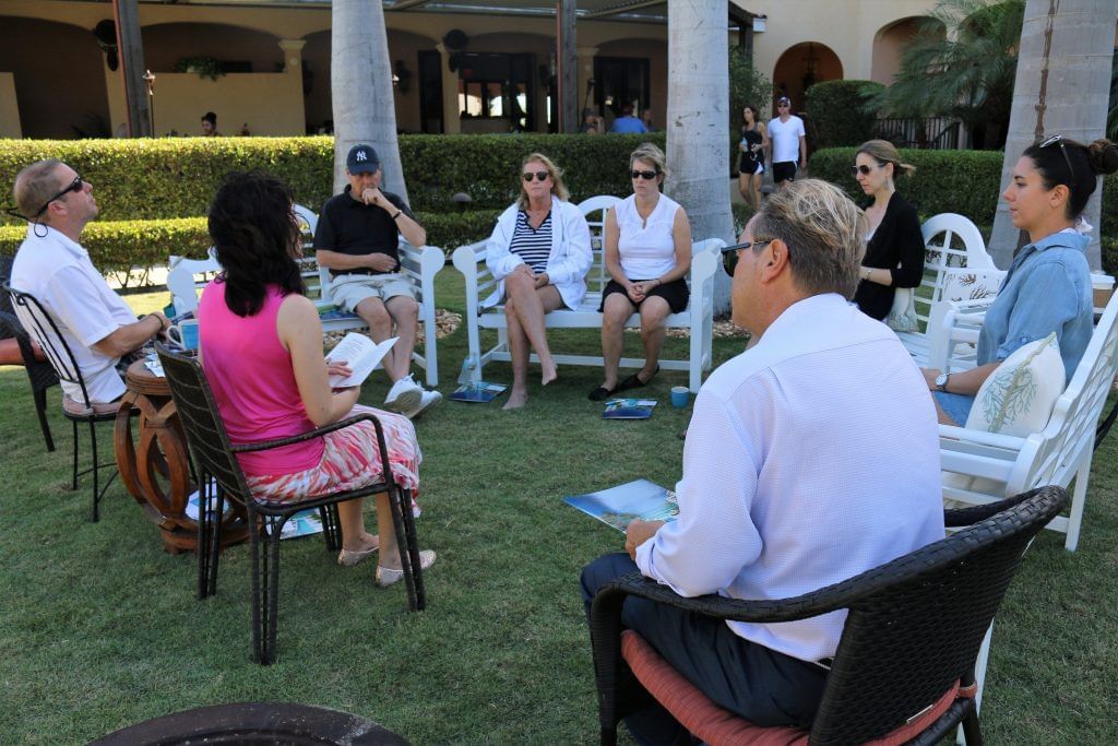 Group of people discussing at The Somerset On Grace Bay