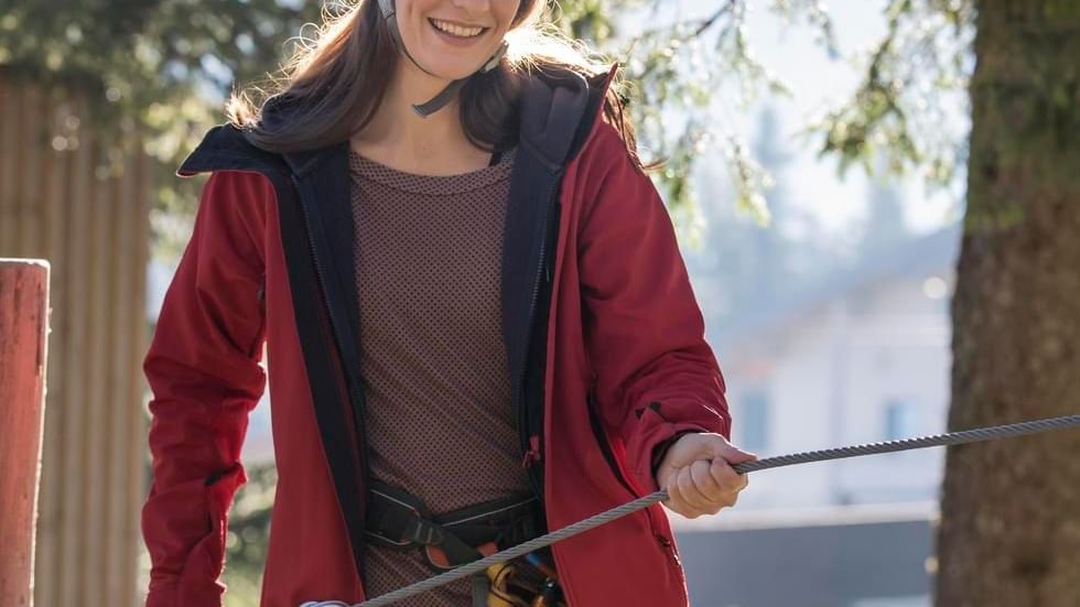 A girl engaged in high-wire course near Falkensteiner Hotels