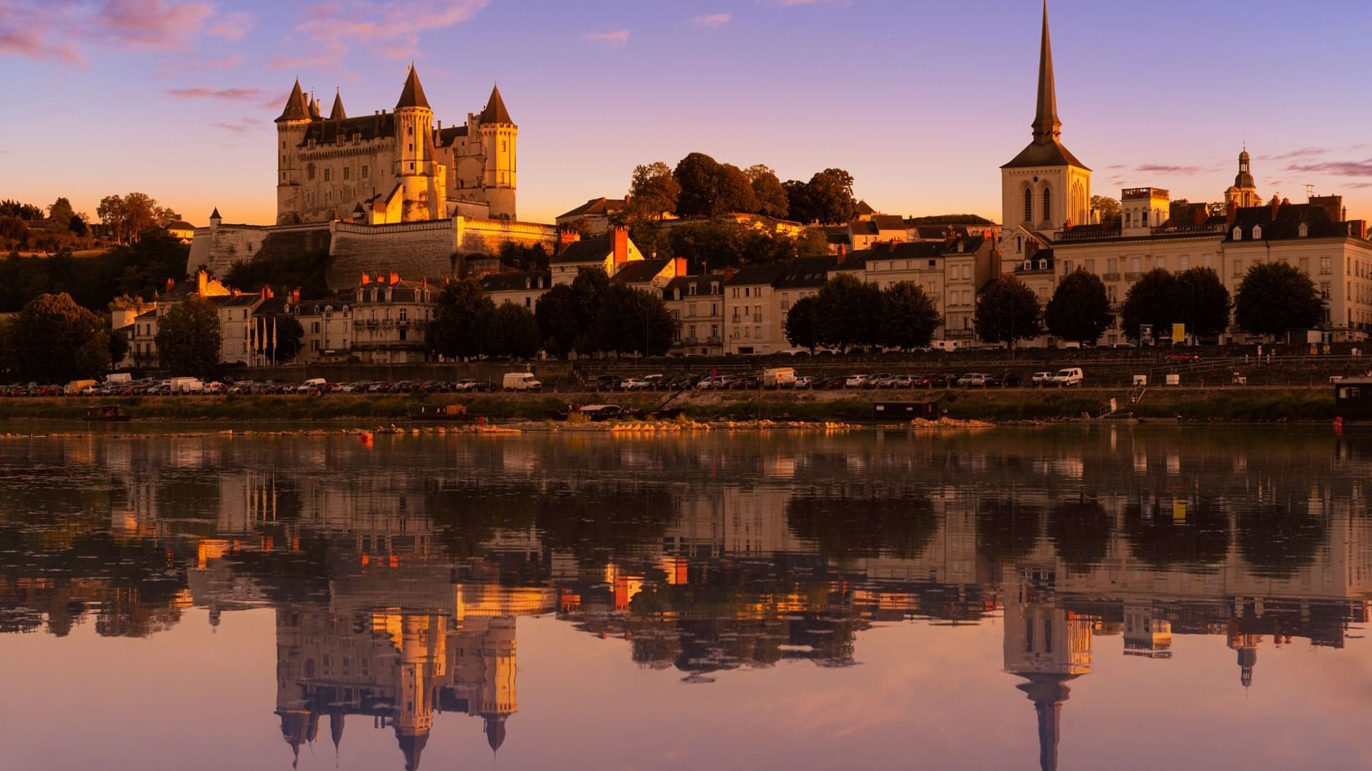 Saumur city by the lake in the evening near Originals Hotels