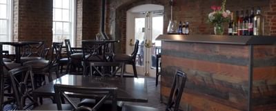 Dining table arrangement in the Bar at River Street Inn