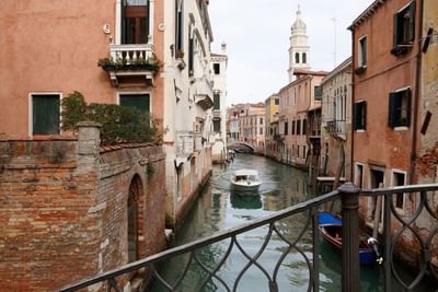 Two boats in a canal in the city of Venice near Hotel Bisanzio