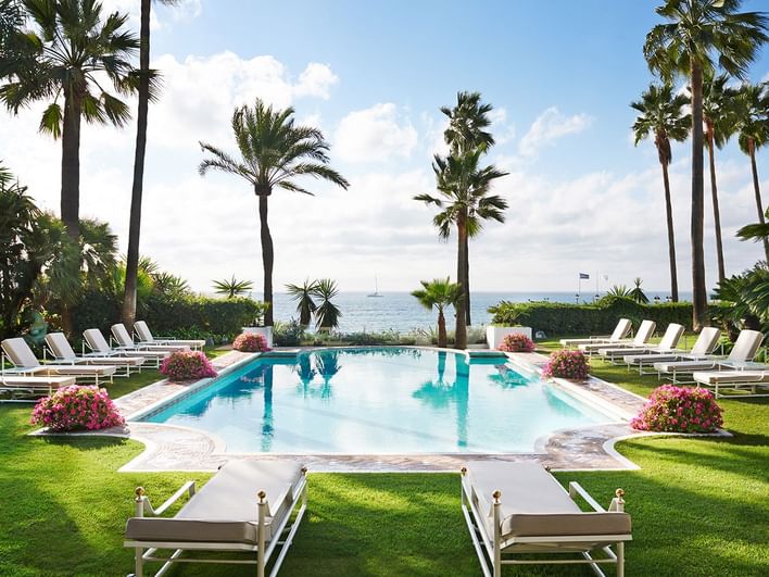 Outdoor pool with pool beds & sea view at Marbella Club Hotel