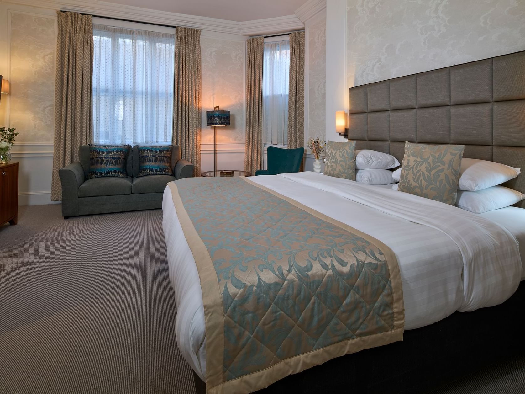 Spacious Club Family room with king-size bed, sofa bed, seating area and large windows at Sloane Square Hotel
