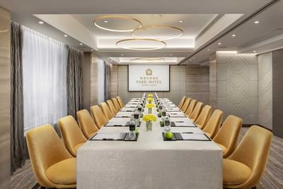 Meeting Venue with a long table & screen at Park Hotel Hong Kong
