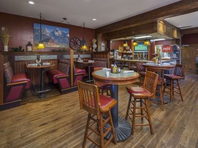 Dining area with wooden floors and a mountain painting in Bandannas Bar and Grill at Hotel Park City Autograph Collection 