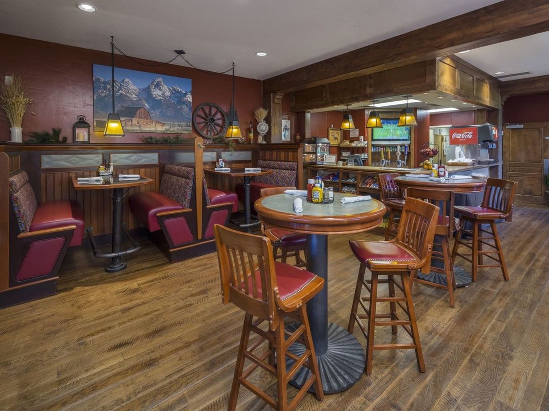 Dining area with wooden floors and a mountain painting in Bandannas Bar and Grill at Hotel Park City Autograph Collection 