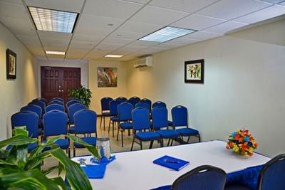Meeting room with blue chairs and a table at Dover Beach Hotel