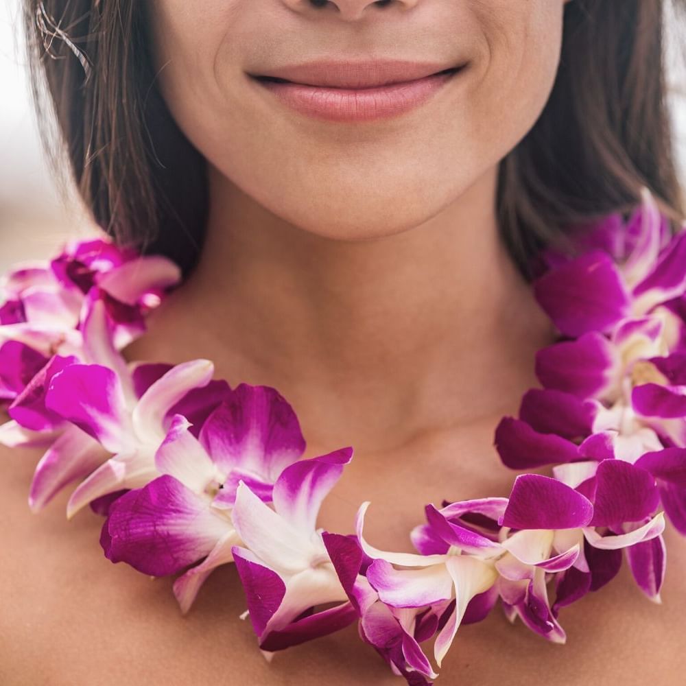 Close-up of lady wearing a lei outdoors at Waikiki Resort Hotel by Sono