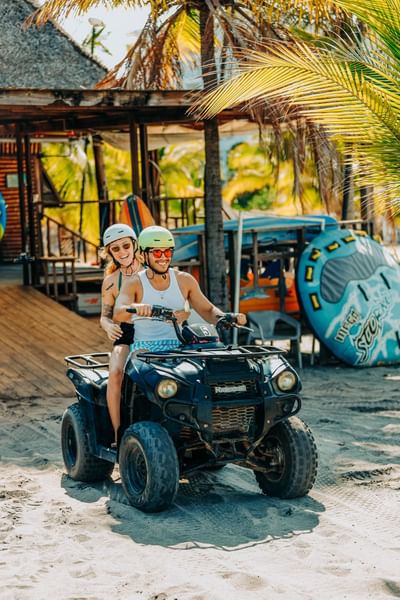 Couple riding a buggy on the beach at Playa Blanca Beach Resort