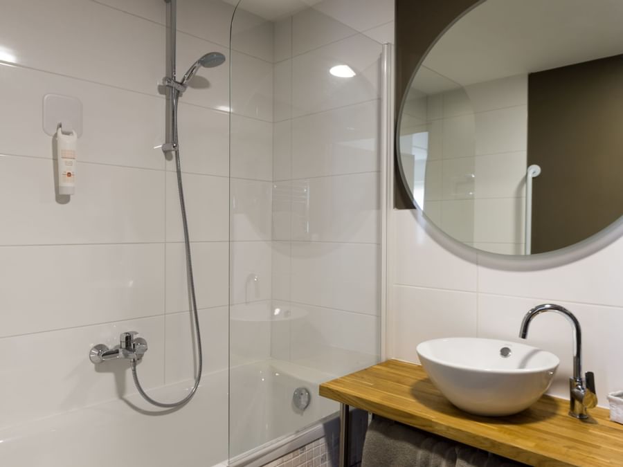 Bathroom shower & vanity area in a room at Hotel Bulles
