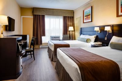 two beds in hotel room with window