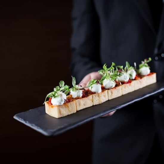 Waiter holding appetizers at Pullman Sydney Olympic park 