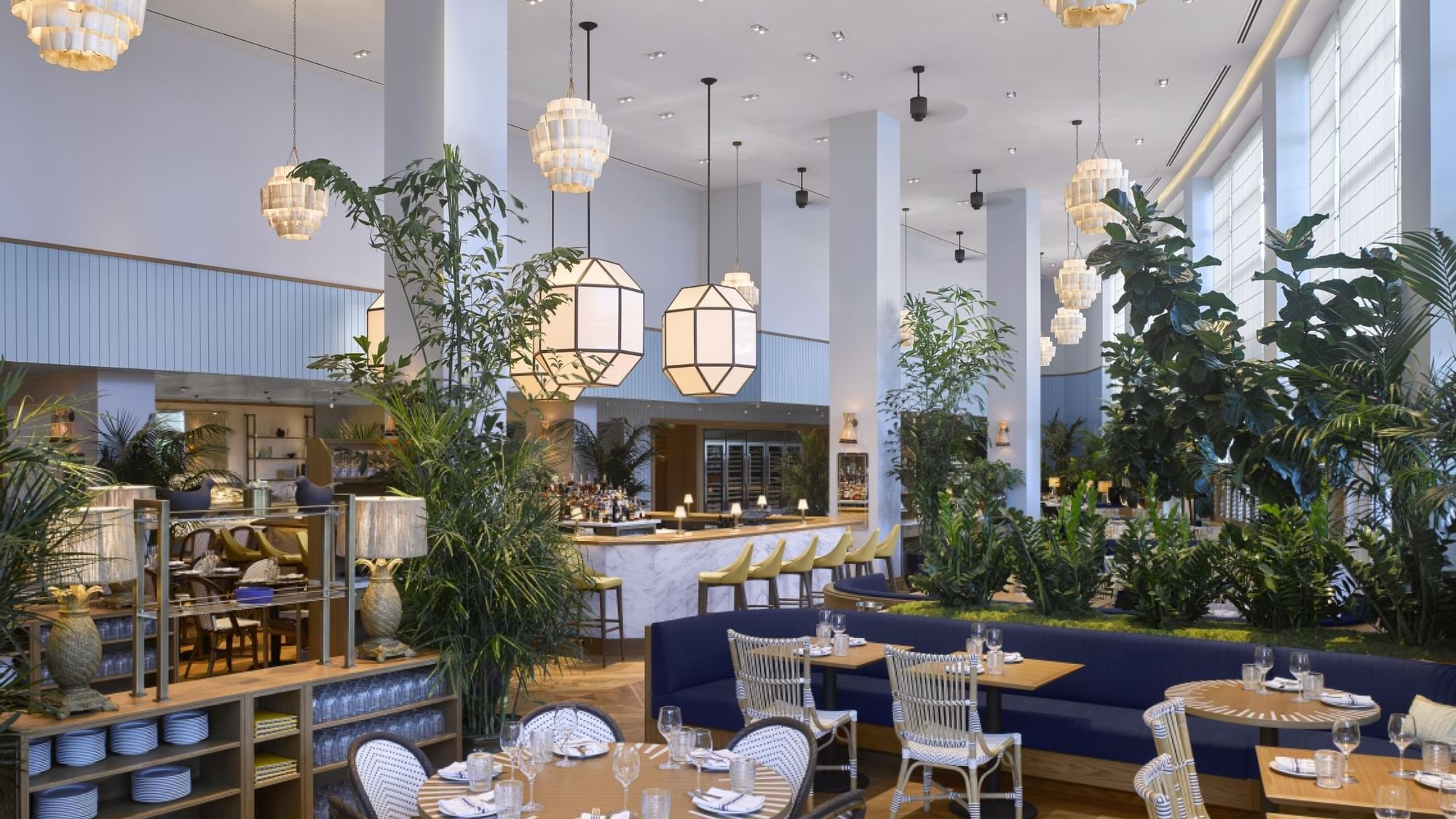 Dining area with lush greenery in Point Royal Restaurant at Diplomat Beach Resort