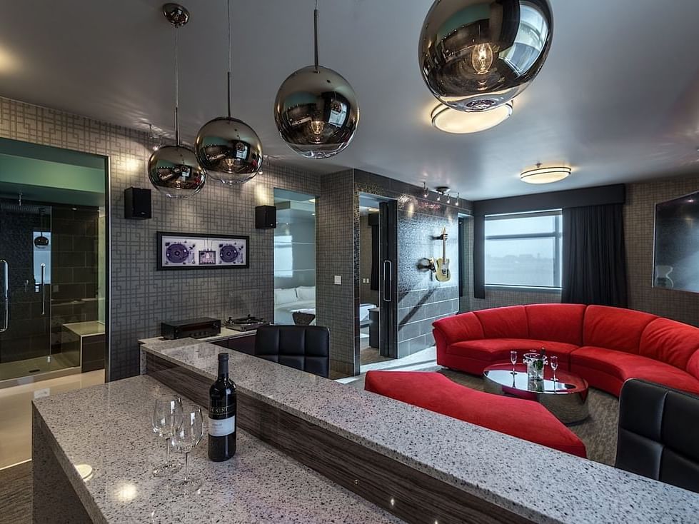 Lounge area with sofas by the Vinyl Bar in Vinyl Themed Suite at Applause Hotel Calgary