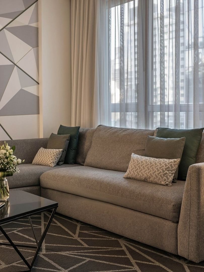 Élégant salon de la suite junior, au décor moderne et à l'ameublement confortable, au Warwick Le Crystal – Montréal.