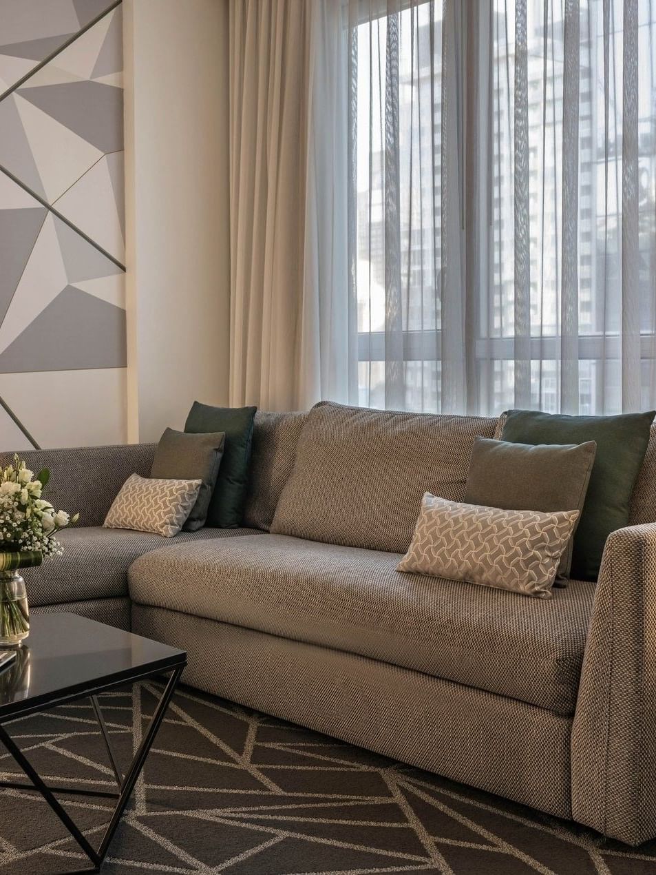 Junior Balcony Suite living area with coffee table near the window at Warwick Le Crystal Montreal