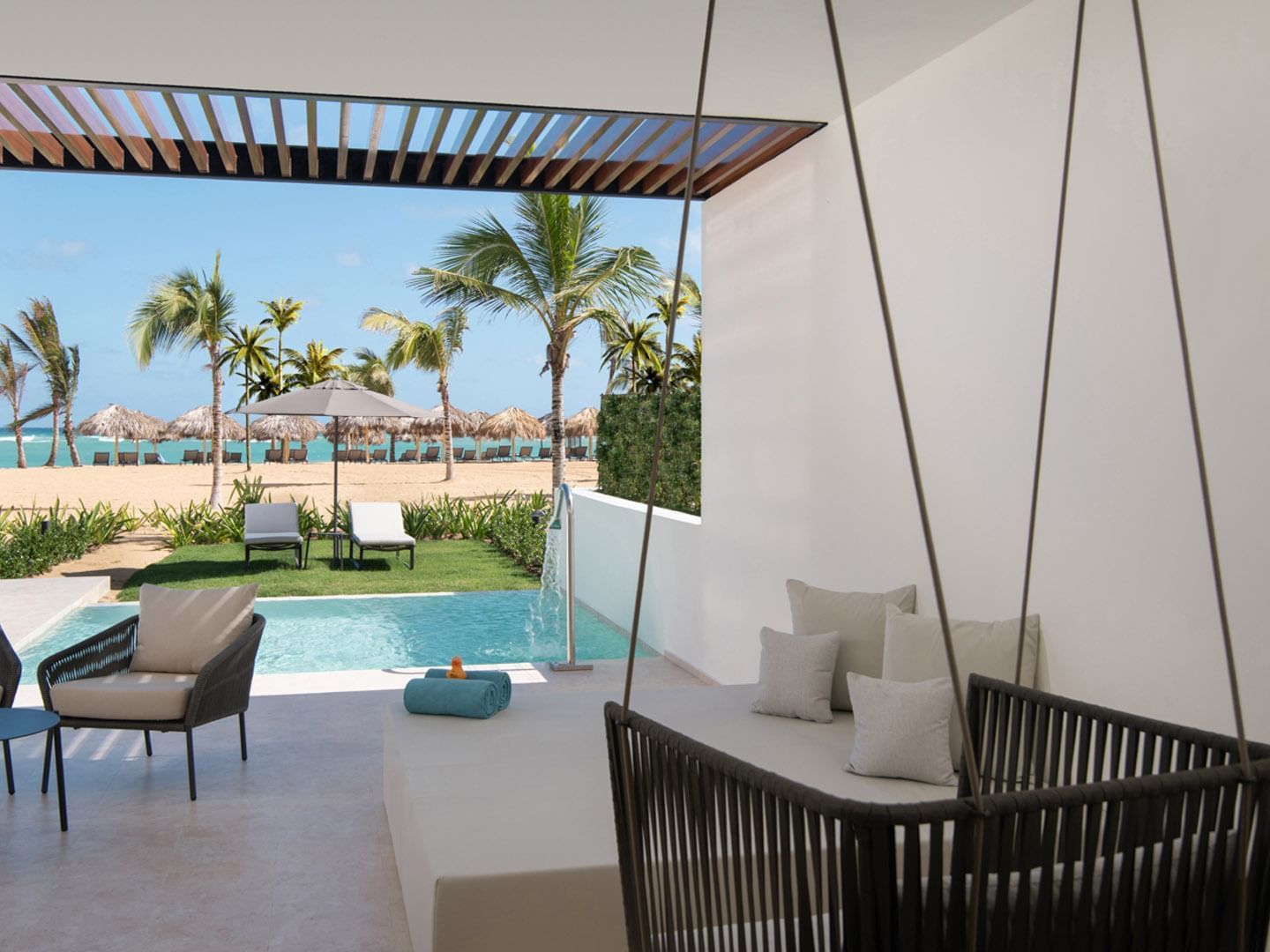 Pool area with loungers in Tierra Suite at Live Aqua Punta Cana