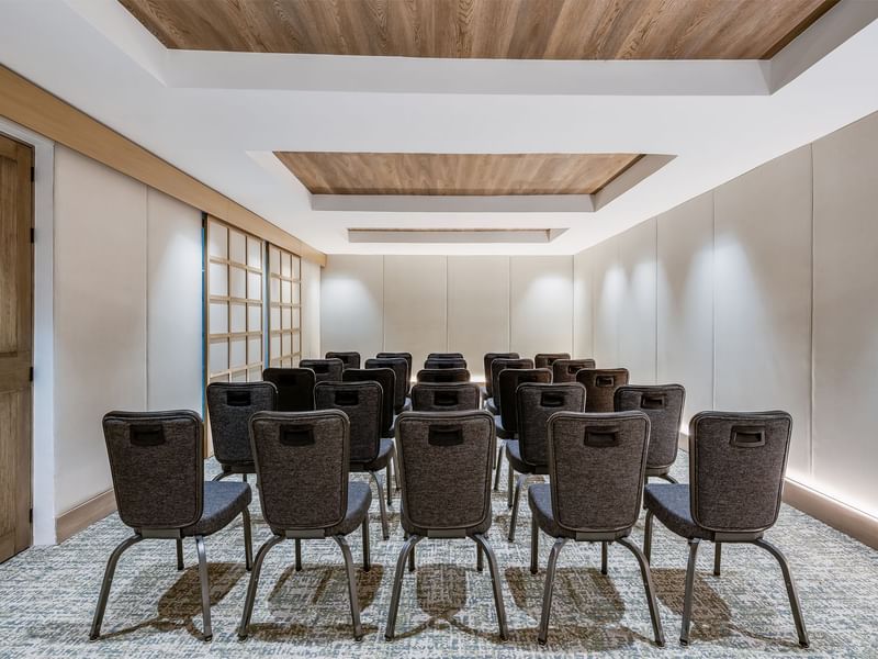 Stylish conference room with a wooden, triangular ceiling and soft lighting at Grand Fiesta Americana