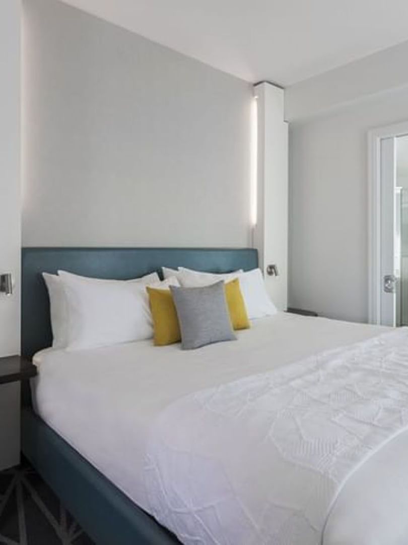 Bed by vanity area in Penthouse René-Lévesque at Warwick Le Crystal Montreal