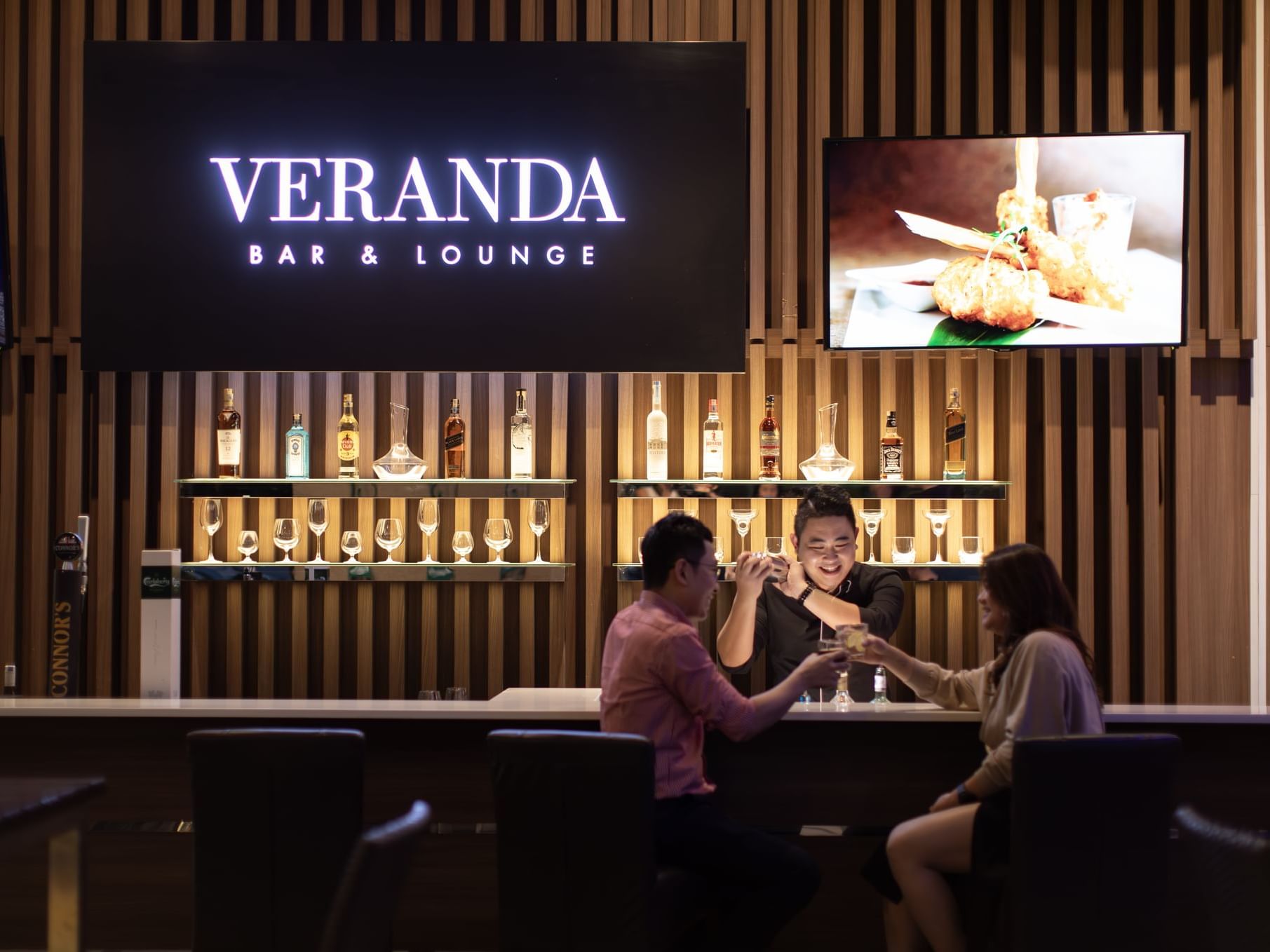 People near bar counter in Veranda Bar at VE Hotel & Residence