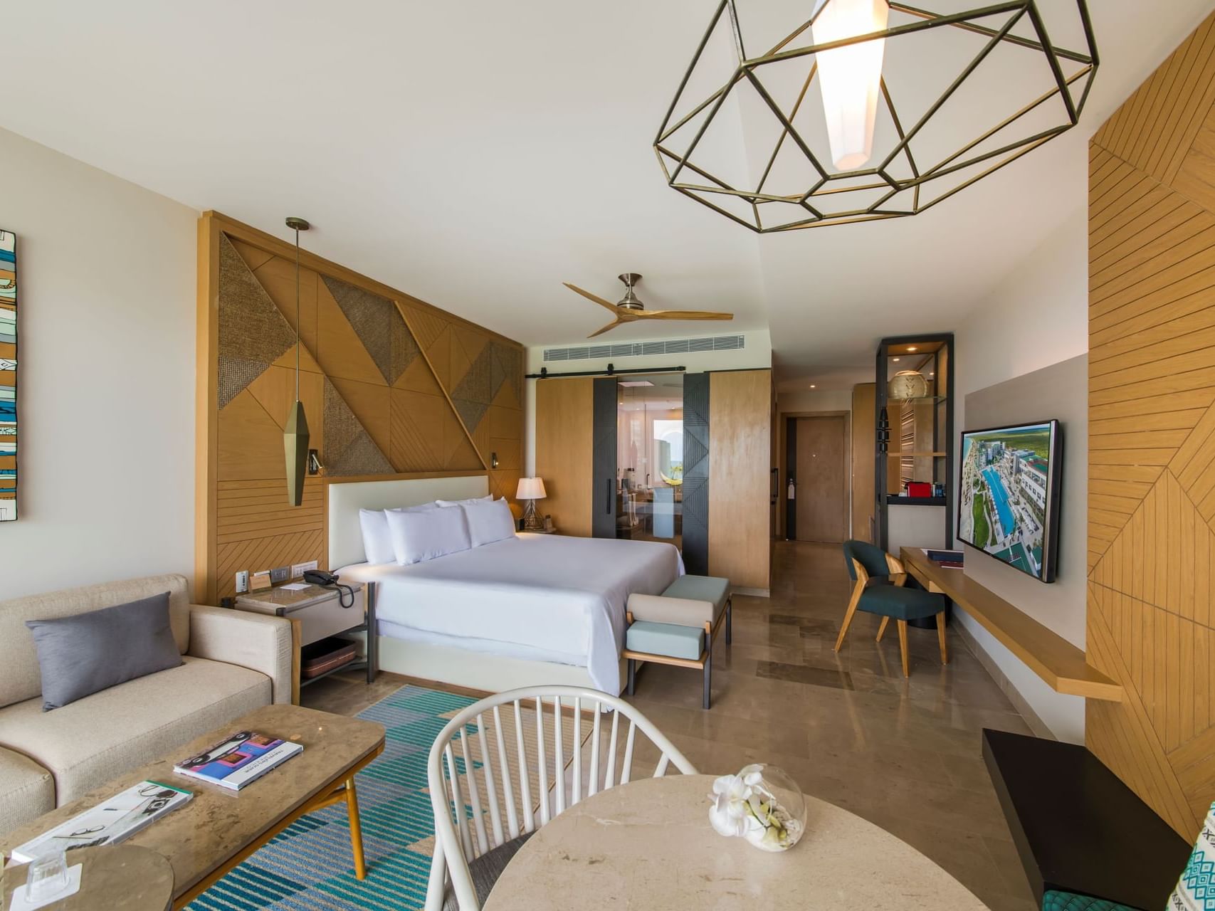 King bed, TV & living area of Junior Suite Haven Riviera Cancun