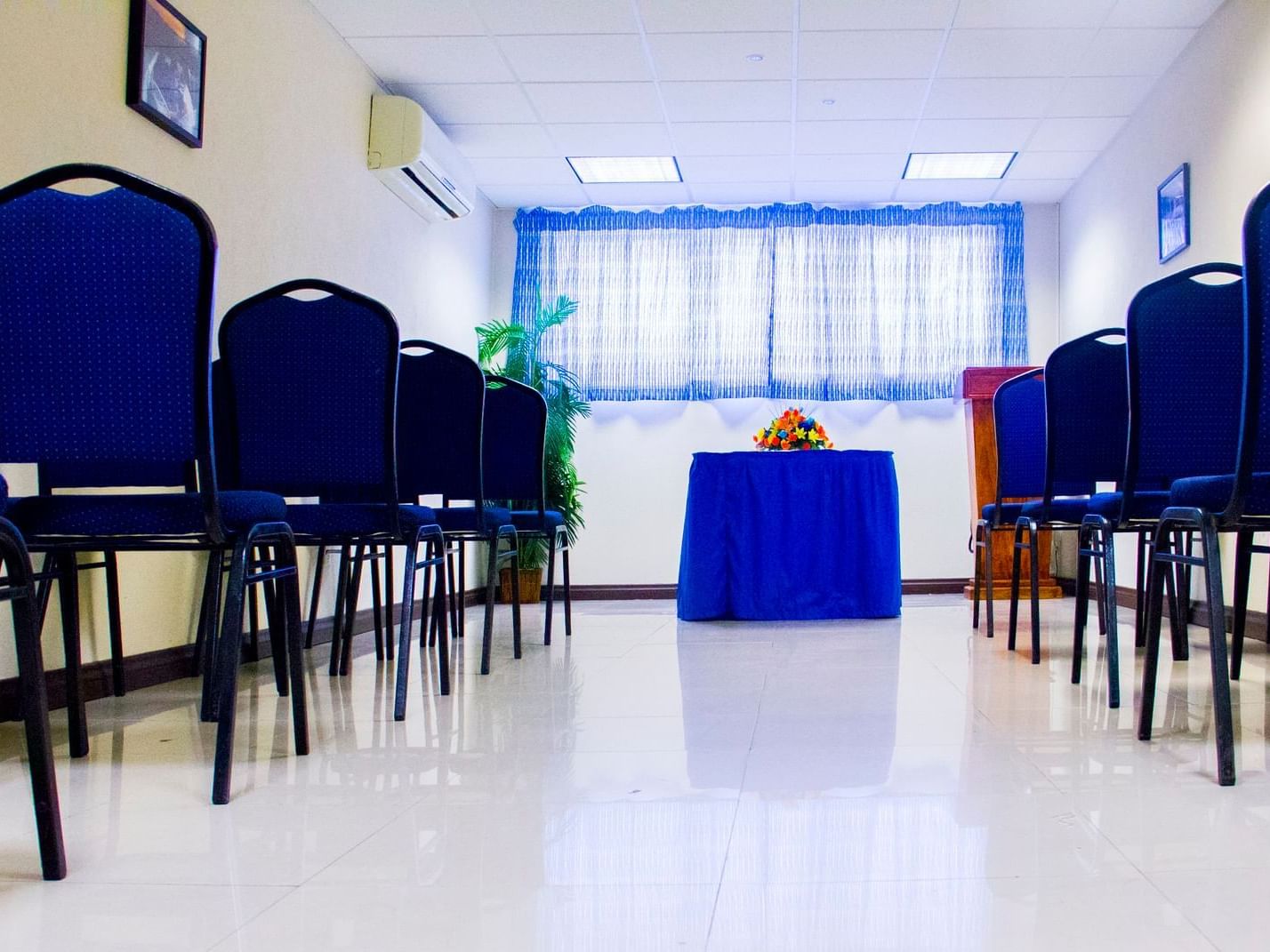 A meeting room with blue chairs and a table at Dover Beach Hotel