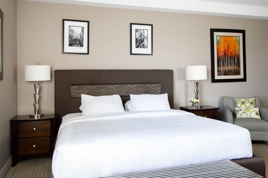 King bed, comfy pillows & bedside cupboards with lamps in King Superior Den at Retro Suites Hotel